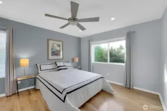 Spacious primary bedroom with ceiling fan & added canned lighting.