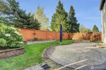 Gorgeous patio, built up garden beds, lighting around fence for extra ambiance