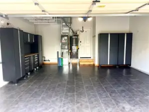 Wonderfully finished garage with luxury vinyl tile flooring & great cabinets for storage