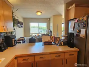 Kitchen looks out through the bonus room to the beautiful views outside.