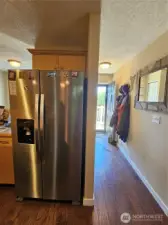Large kitchen with new fridge.