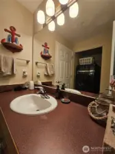 Guest bathroom off the hallway, laundry room also tucked away here.