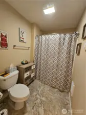 Full guest bathroom with separate shower and laundry room.