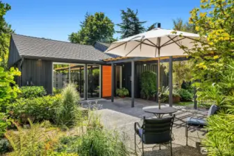 A sunny patio greets you upon entry into the front courtyard.