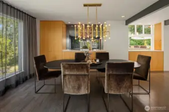White oak and a smoked mirror create a mood in the formal dining area...open just the right amount to the kitchen/hang-out area beyond.