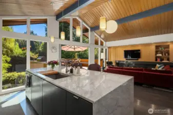Floor-to-ceiling windows (and the deck) look down upon the secret-garden of a backyard.  Tall perimeter trees  provide amazing privacy, with the large corner lot also allowing abundant light to grace the yard, deck, and home.