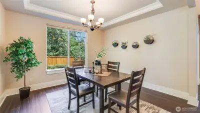 Formal dining features tray ceilings and plenty of space for dining at home or hosting your next gathering.