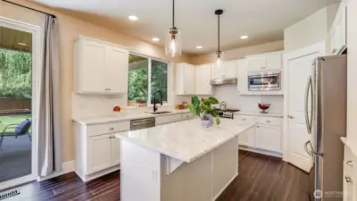 This kitchen really shines with all white cabinetry, stunning countertops, engineered hardwood floors and all stainless steel appliances.