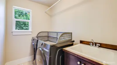 Conveniently located upstairs laundry room with utility sink!