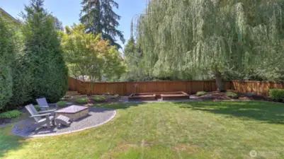 Enjoy this private and spacious backyard with a mature Willow tree adding charm and shade for relaxing.