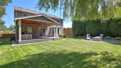 View of the yard looking to the back of the home really showcasing all of its beauty.