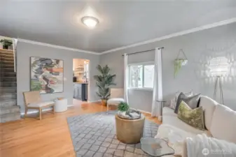 This living room has classic crown molding highlighted by real hardwood flooring.