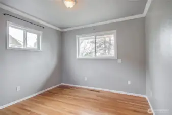 2nd bedroom downstairs also has hardwood floors.crown molding and two windows making this room light and bright.