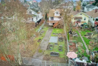 Fully fenced backyard with raised planting beds a space to grow your own garden or create outdoor living areas.