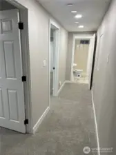 downstairs hallway with 2 bedrooms and 1 - 3/4 bath