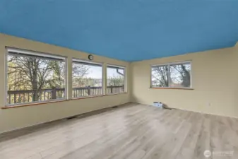 Living room area featuring large picture windows and views out toward the harbor.