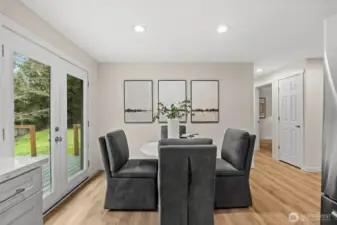 Designed for effortless entertaining, this dining area flows seamlessly through elegant French doors onto a spacious back deck.