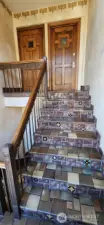 Beautifully tiled staircase to entry door