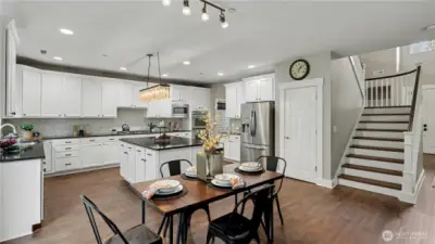 The thoughtfully designed kitchen provides ample storage, generous counter space, and an open layout.