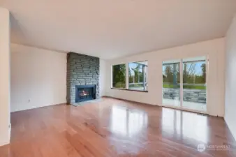 We love this living room with its gas burning fireplace and outlook to the pond and running track.