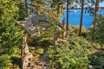 The home is nestled amongst tall trees with gorgeous southern views of Puget Sound, Mt. Rainier and Tacoma.