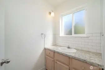 Main floor 3/4 bath, shower and toilet behind door