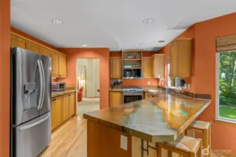 Spacious kitchen with high end countertops.