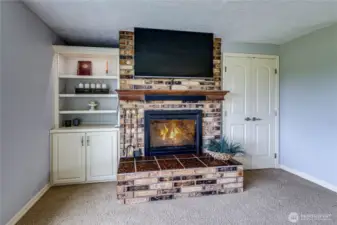 Floor to ceiling brick fireplace.