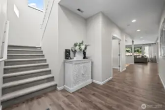 Light and bright, the front hallway is wide, as are the stairs - this house has a roomy and spacious feeling.