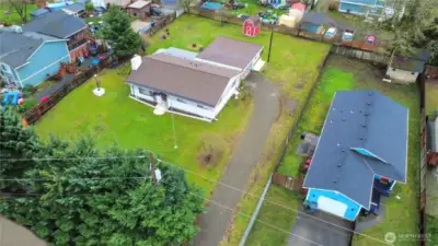 Drone shot of home on large lot. Fully Fenced.