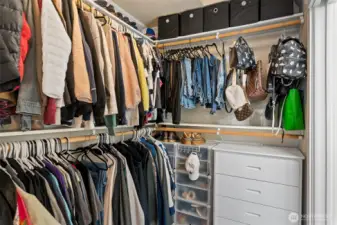 Spacious primary closet with built-in storage and organization