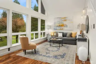 Living Room with soaring ceilings and floor-to-ceiling windows for natural light.