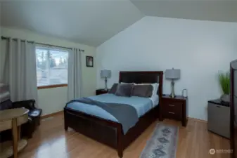 Primary bedroom has a vaulted ceiling.