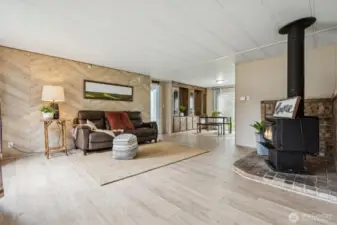 Interesting wood design wall in this open living/dining with new flooring