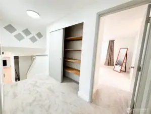 Upper landing area has ample closet storage