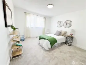 Second bedroom with new carpet and paint ready is so large that it can easily fit a king-size bed.