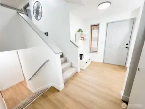 Entry area is well lit, has a large coat closet to the right, and leads to additional bonus area, laundry room, bathroom and garage.