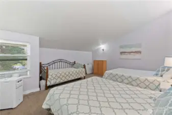 Upper level loft with 3 beds.