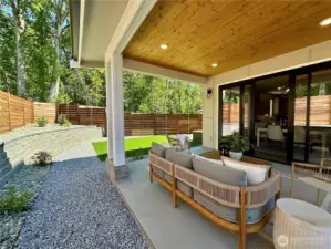 Large covered patio looks out to greenspace