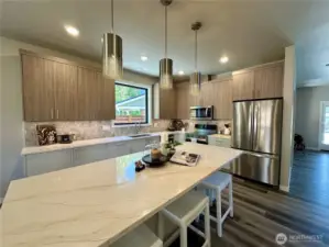 Massive quartz island with storage and eating space.
