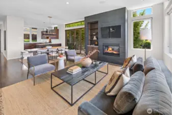 Expansive great room is designed for entertaining. Featuring an open kitchen with eating bar leading to ample dining space and living room featuring gas fireplace with walnut built-in shelving and cabinetry