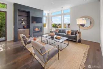 Living room featuring gas fireplace and western views across the neighborhood towards the Olympics and even Green Lake and Downtown Seattle