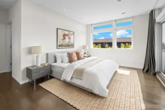 Primary Suite featuring large walk-in closet and spa-inspired bathroom, plus a deck with views