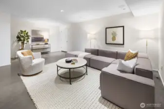 Exceptional rec room/media room, featuring radiant-heated polished concrete floors, built-in cabinets and shelving, and 5.1 surround sound