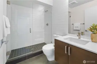 Downstairs bathroom featuring hand-built walk-in shower and walnut vanity