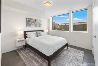 Fourth bedroom is the perfect guest space with West facing wall of windows
