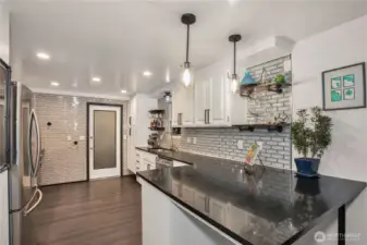 This kitchen is stunning, you have to see it in person!!  Beautiful granite counters, new lighting, glass tile backsplash, newer appliances, cabinets have been resurfaced & some a newer cabinets added.  Door goes to laundry/mud room and bonus room