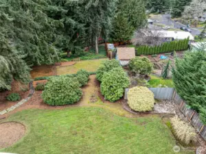 The lot goes all the way down to the fence line behind the large fir trees!!