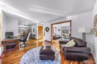 Open-concept living space showcases warm finishes and seamless flow between kitchen, dining, and living areas. Designed for comfort and functionality, this layout adapts easily to both entertaining and quiet evenings at home.