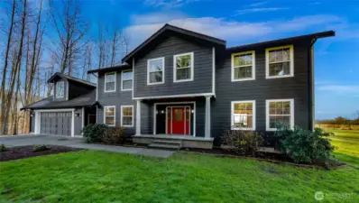 Rear exterior view emphasizes the home’s setting within open land, offering privacy without isolation. Space around the home allows for gardens, animals, or future expansion.